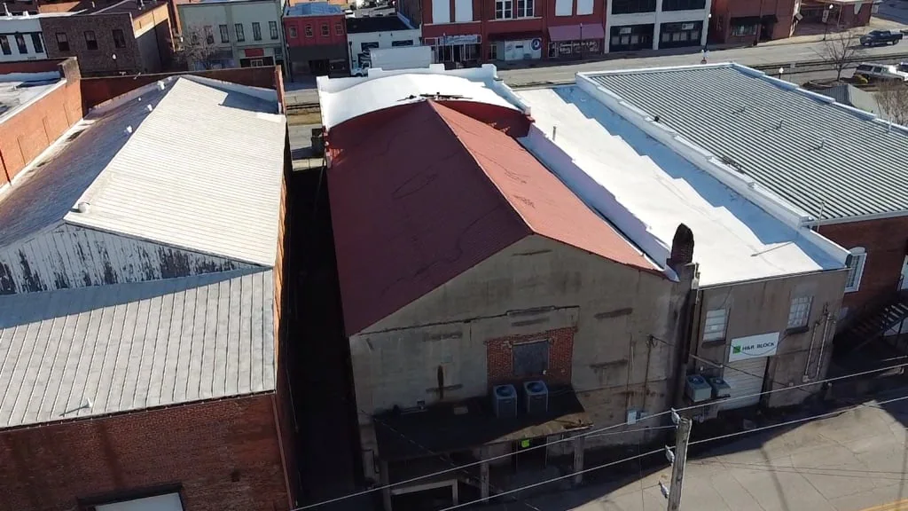 Aerial view of completed metal and low-slope commercial roofing