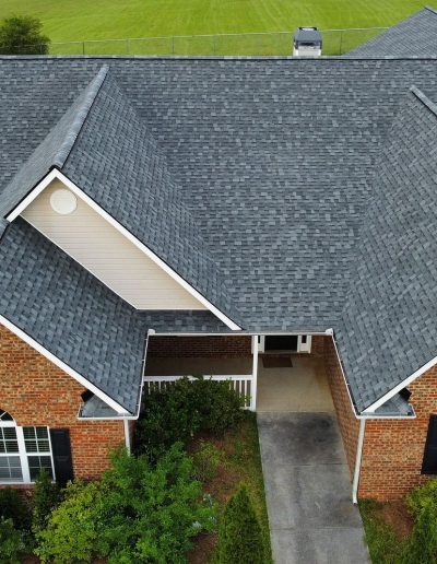 Charcoal shingle roof on brick ranch with breezeway, aerial view